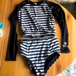 Black and white striped rash guard and high waisted bikini bottoms set